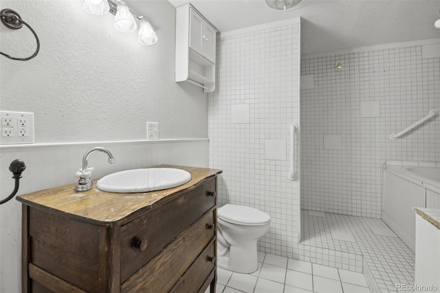 bathroom with vanity, tile patterned floors, crown molding, toilet, and a tile shower