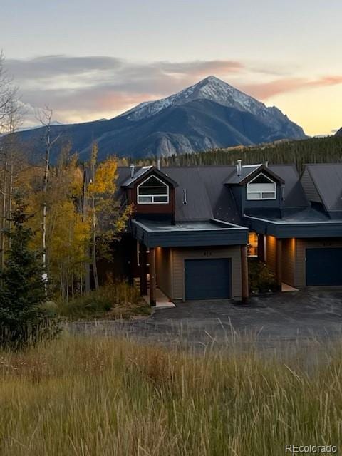 61 Cydney Ln Unit A, Silverthorne, CO 80498 - view of front of house with an attached garage, a mountain view, and driveway
