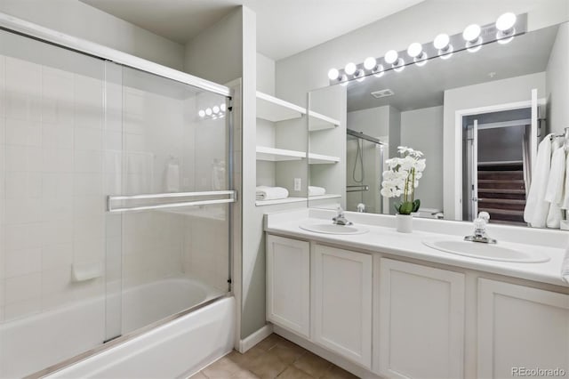 61 Cydney Ln Unit A, Silverthorne, CO 80498 - full bathroom featuring tile patterned flooring, combined bath / shower with glass door, and double vanity