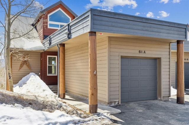 61 Cydney Ln Unit A, Silverthorne, CO 80498 - view of snowy exterior with a garage
