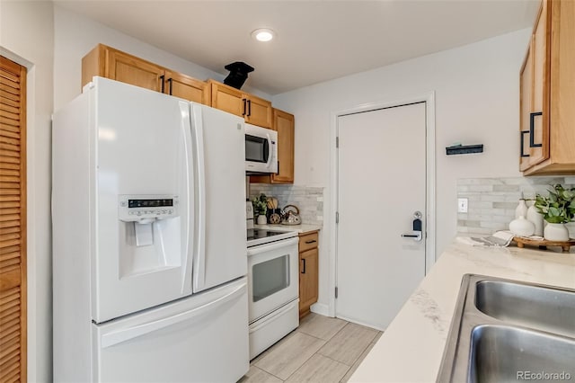 1060 Grove St, Denver, CO 80204 - kitchen featuring white appliances, light countertops, backsplash, and recessed lighting