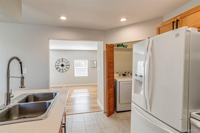 1060 Grove St, Denver, CO 80204 - kitchen with white fridge with ice dispenser, independent washer and dryer, recessed lighting, and light countertops