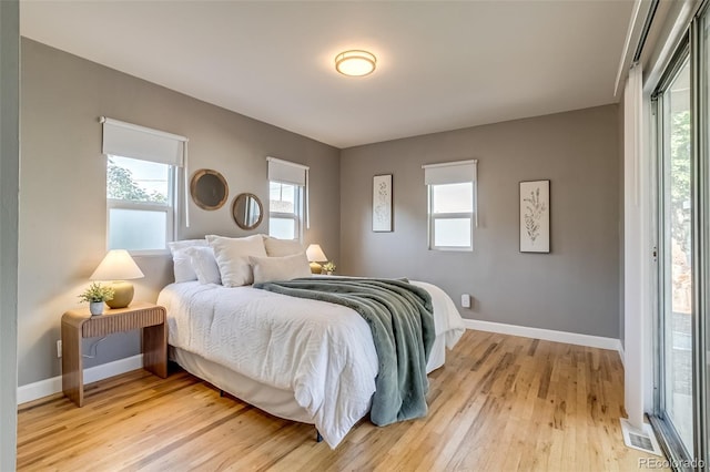 1060 Grove St, Denver, CO 80204 - bedroom with light wood-style flooring and multiple windows
