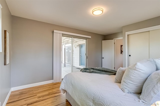 1060 Grove St, Denver, CO 80204 - bedroom featuring access to outside, light wood-style flooring, and a closet