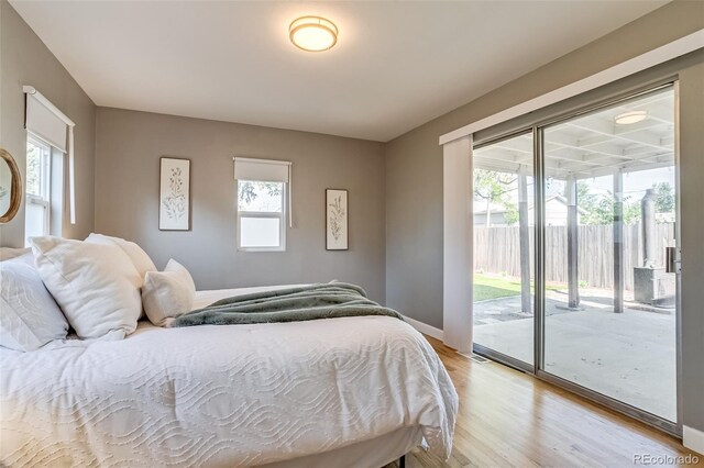 1060 Grove St, Denver, CO 80204 - bedroom featuring light wood-type flooring and access to exterior