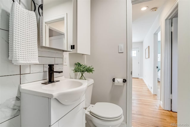 1060 Grove St, Denver, CO 80204 - half bath with vanity, wood finished floors, and recessed lighting