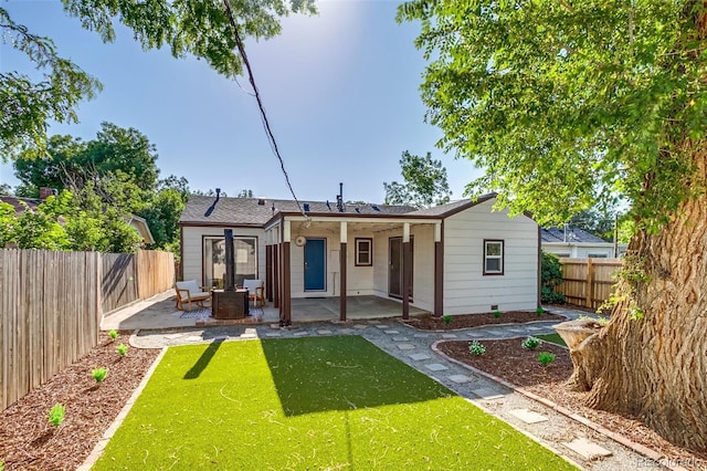 1060 Grove St, Denver, CO 80204 - rear view of property with a patio, a fenced backyard, and an outdoor fire pit