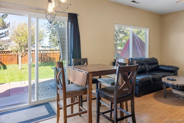 dining area with hardwood / wood-style flooring and an inviting chandelier