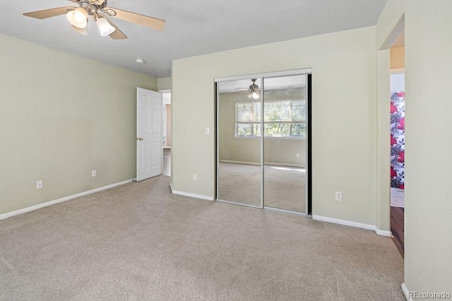 unfurnished bedroom with light carpet, a closet, and ceiling fan