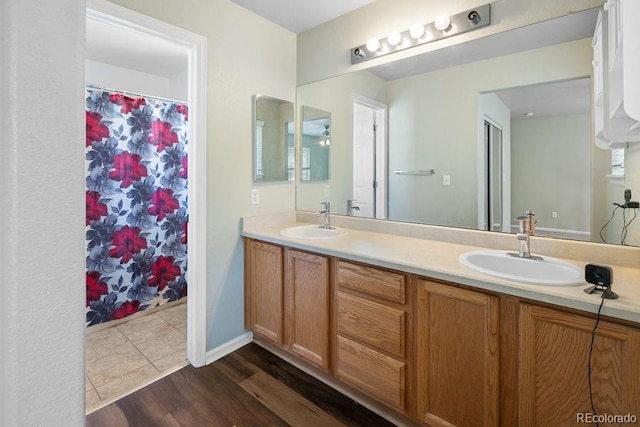 bathroom with hardwood / wood-style floors and vanity