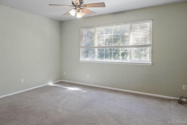 carpeted spare room with ceiling fan