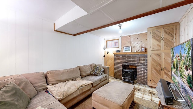 living room featuring beamed ceiling, wood walls, and a wood stove