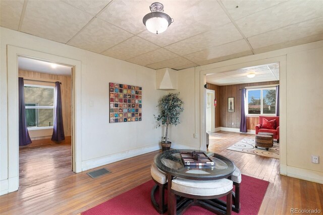 interior space featuring a paneled ceiling and wood-type flooring