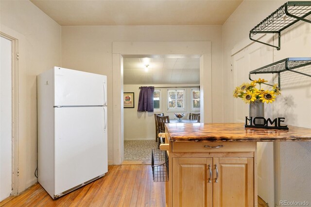 kitchen featuring wood counters, white refrigerator, and light wood-type flooring