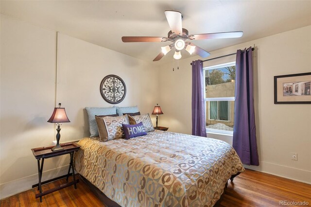 bedroom featuring dark hardwood / wood-style flooring and ceiling fan