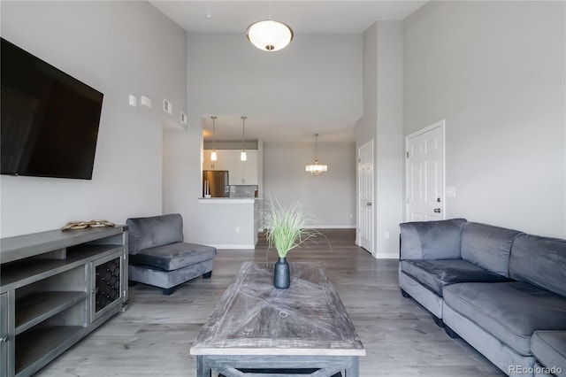 15700 E Jamison Dr Unit 305, Englewood, CO 80112 - living area with a towering ceiling, wood finished floors, and a chandelier