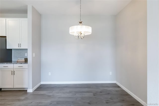 15700 E Jamison Dr Unit 305, Englewood, CO 80112 - unfurnished dining area featuring a chandelier and wood finished floors
