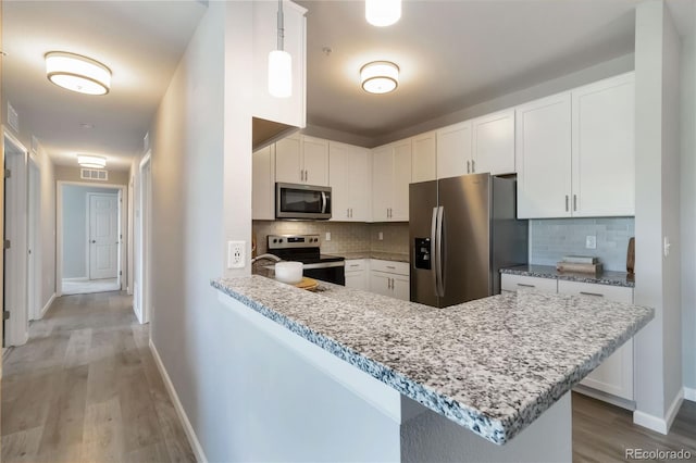 15700 E Jamison Dr Unit 305, Englewood, CO 80112 - kitchen with stainless steel appliances, light wood-style flooring, tasteful backsplash, white cabinetry, and light stone countertops