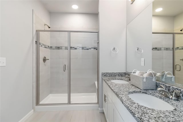 15700 E Jamison Dr Unit 305, Englewood, CO 80112 - full bathroom with double vanity, a shower stall, and recessed lighting