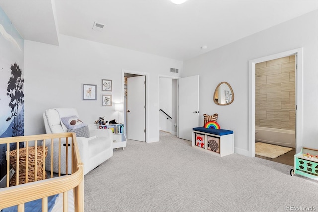 carpeted bedroom with visible vents and connected bathroom