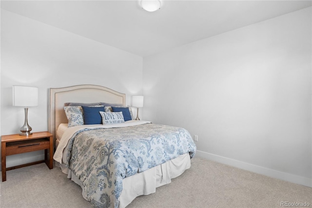 carpeted bedroom featuring baseboards