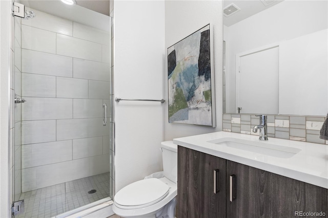 bathroom featuring tasteful backsplash, visible vents, toilet, a stall shower, and vanity