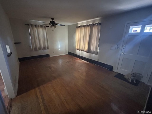 foyer entrance featuring ceiling fan and dark wood-type flooring