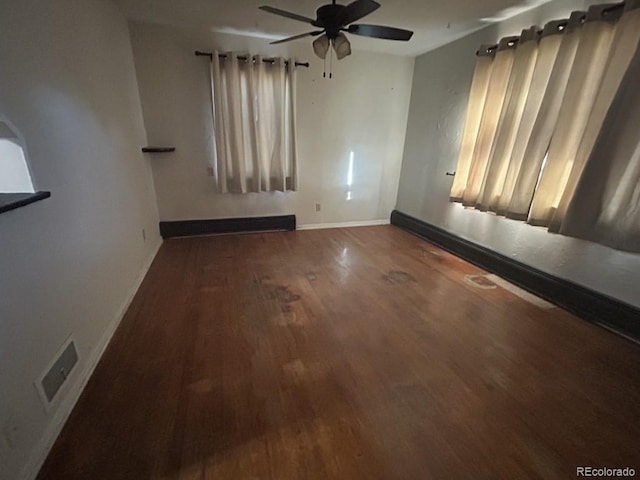 empty room featuring ceiling fan and dark hardwood / wood-style floors