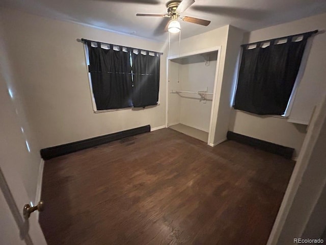 unfurnished bedroom featuring ceiling fan, a closet, and dark hardwood / wood-style flooring