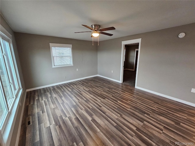 empty room featuring ceiling fan and dark hardwood / wood-style flooring