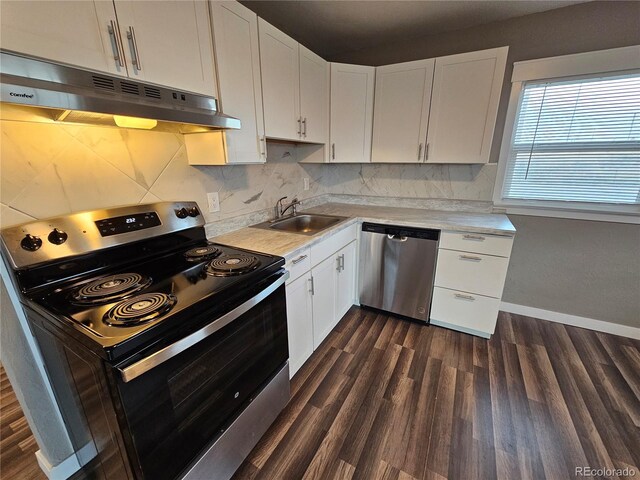 kitchen featuring appliances with stainless steel finishes, tasteful backsplash, dark wood-type flooring, sink, and white cabinetry