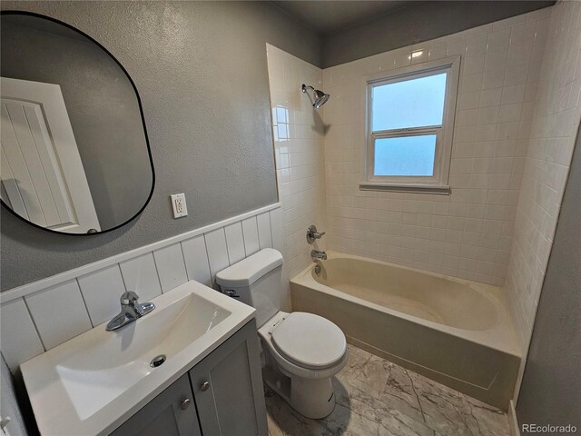 full bathroom with vanity, toilet, and tiled shower / bath