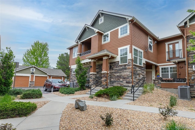 7130 Simms St Unit 206, Arvada, CO 80004 - craftsman-style house featuring a balcony, stone siding, and central AC unit