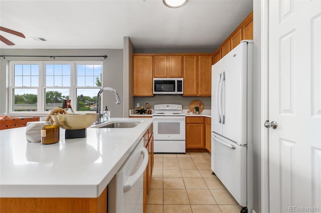 7130 Simms St Unit 206, Arvada, CO 80004 - kitchen featuring white appliances, a sink, light countertops, light tile patterned floors, and ceiling fan
