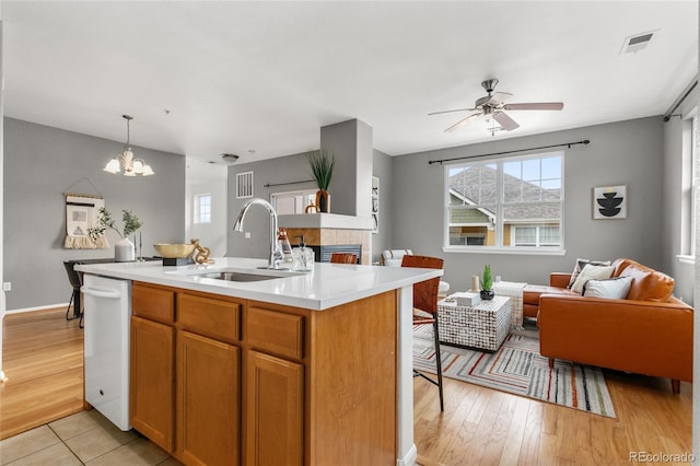 7130 Simms St Unit 206, Arvada, CO 80004 - kitchen with a sink, white dishwasher, open floor plan, light countertops, and ceiling fan