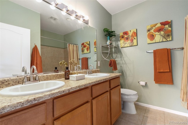 7130 Simms St Unit 206, Arvada, CO 80004 - full bathroom featuring tile patterned flooring, toilet, a shower with curtain, baseboards, and double vanity