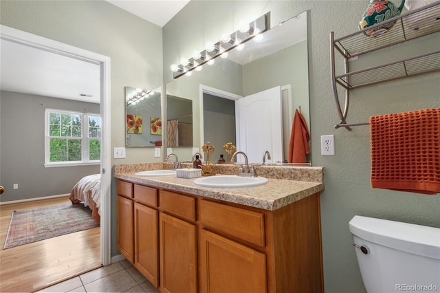7130 Simms St Unit 206, Arvada, CO 80004 - bathroom with toilet, double vanity, a textured wall, tile patterned flooring, and connected bathroom