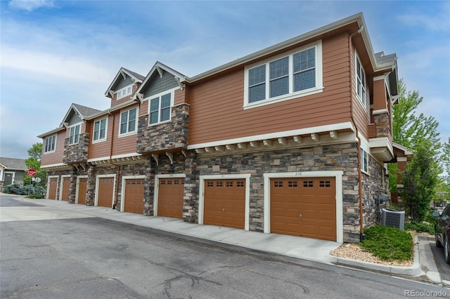 7130 Simms St Unit 206, Arvada, CO 80004 - view of front facade featuring stone siding and an attached garage
