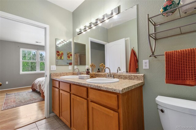 7130 Simms St Unit 206, Arvada, CO 80004 - bathroom featuring double vanity, a textured wall, and tile patterned flooring