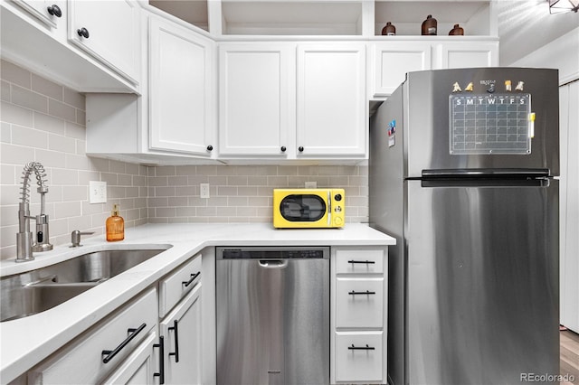 2985 W 46th Ave, Denver, CO 80211 - kitchen featuring stainless steel appliances, a sink, white cabinets, and tasteful backsplash