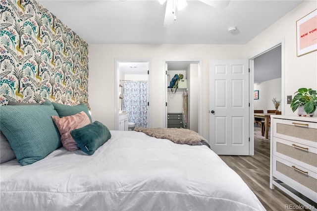2985 W 46th Ave, Denver, CO 80211 - bedroom with wood finished floors, a spacious closet, ensuite bathroom, and ceiling fan