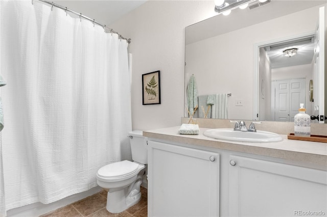 2985 W 46th Ave, Denver, CO 80211 - bathroom featuring toilet, tile patterned floors, and vanity