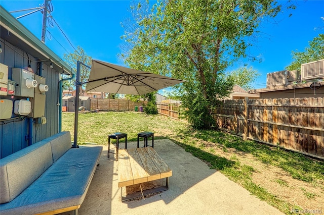2852 W Ellsworth Ave, Denver, CO 80219 - fenced backyard with a patio area and a storage unit