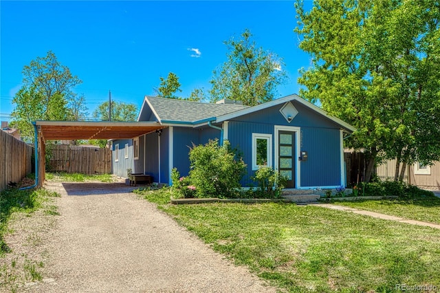 2852 W Ellsworth Ave, Denver, CO 80219 - view of front of home with dirt driveway, roof with shingles, and an attached carport