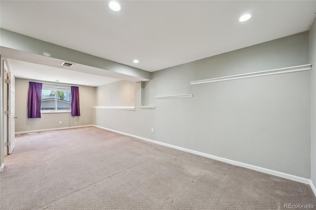 below grade area with visible vents, recessed lighting, baseboards, and carpet