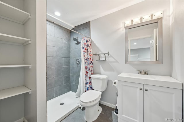 full bath with vanity, baseboards, a stall shower, and toilet