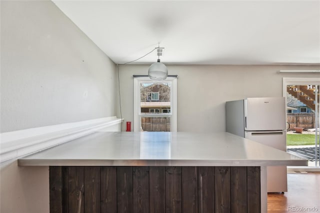kitchen featuring freestanding refrigerator and wood finished floors