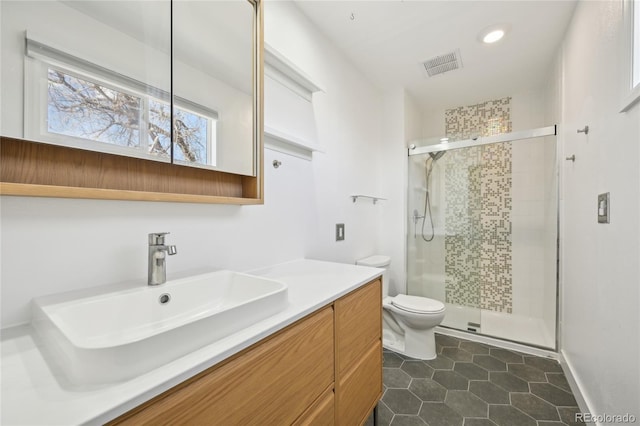 full bathroom featuring visible vents, tile patterned flooring, a stall shower, vanity, and toilet