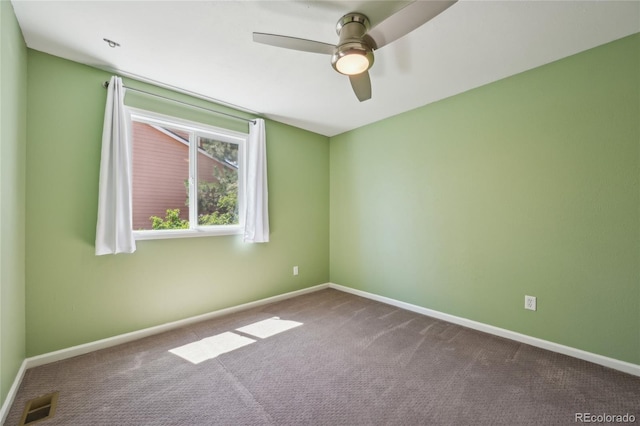 carpeted empty room with a ceiling fan, baseboards, and visible vents