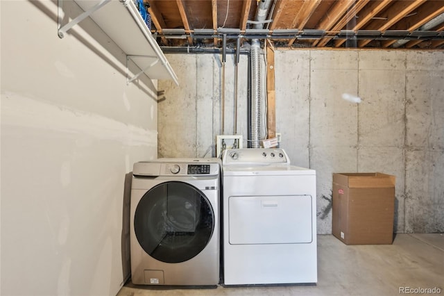washroom with separate washer and dryer and laundry area